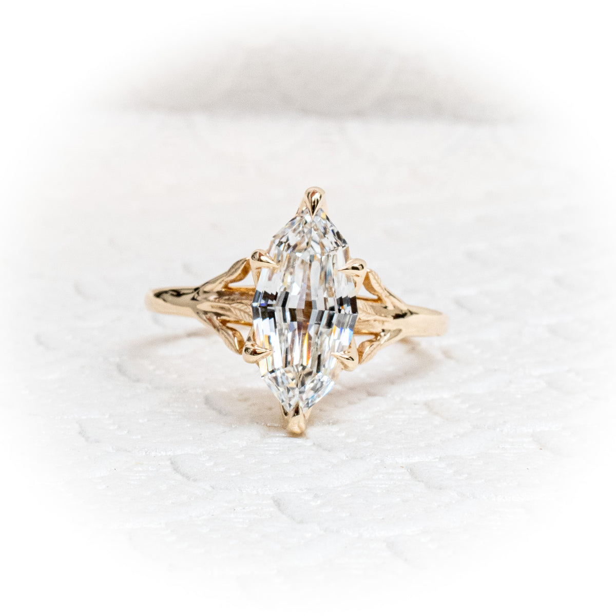 Custom 14K yellow Gold tree of life inspired engagement ring with an evil eye sapphire and Marquise Diamond Centre Stone