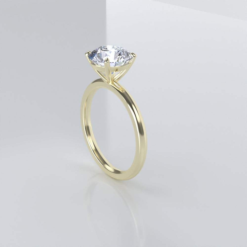 Gold ring with a clear gemstone on a light gray background