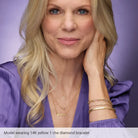 Woman wearing gold jewelry against a purple background