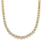 Gold necklace with clear gemstones on a white background