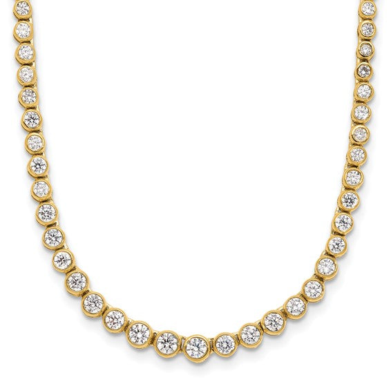 Gold necklace with clear gemstones on a white background