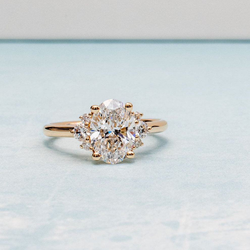 Jacob Mercari Custom Oval Cur Diamond Engagement Ring with Diamond cluster side diamonds.