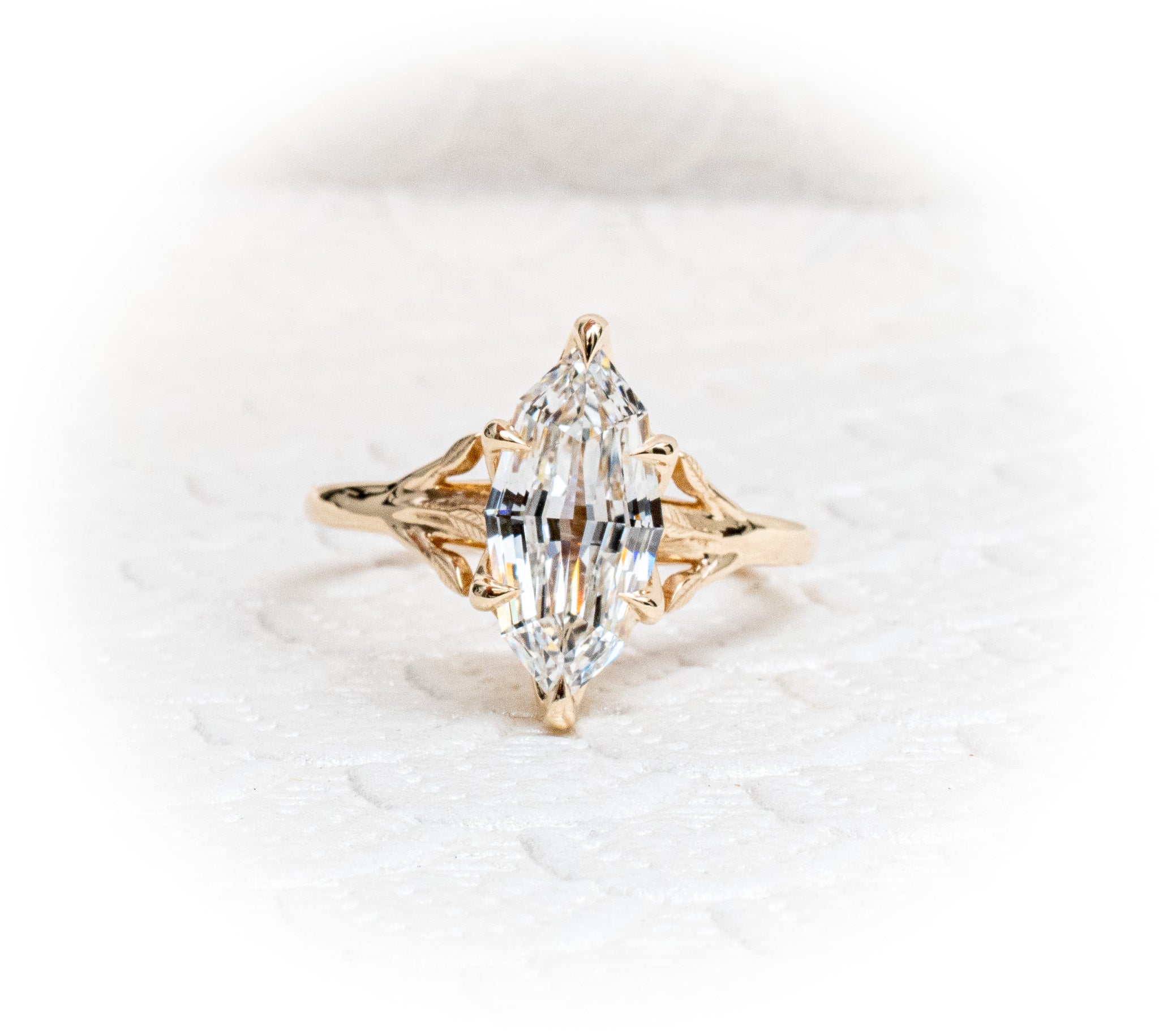 Custom 14K yellow Gold tree of life inspired engagement ring with an evil eye sapphire and Marquise Diamond Centre Stone