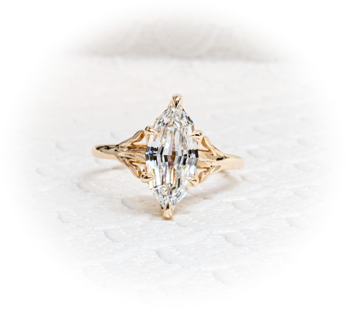 Custom 14K yellow Gold tree of life inspired engagement ring with an evil eye sapphire and Marquise Diamond Centre Stone