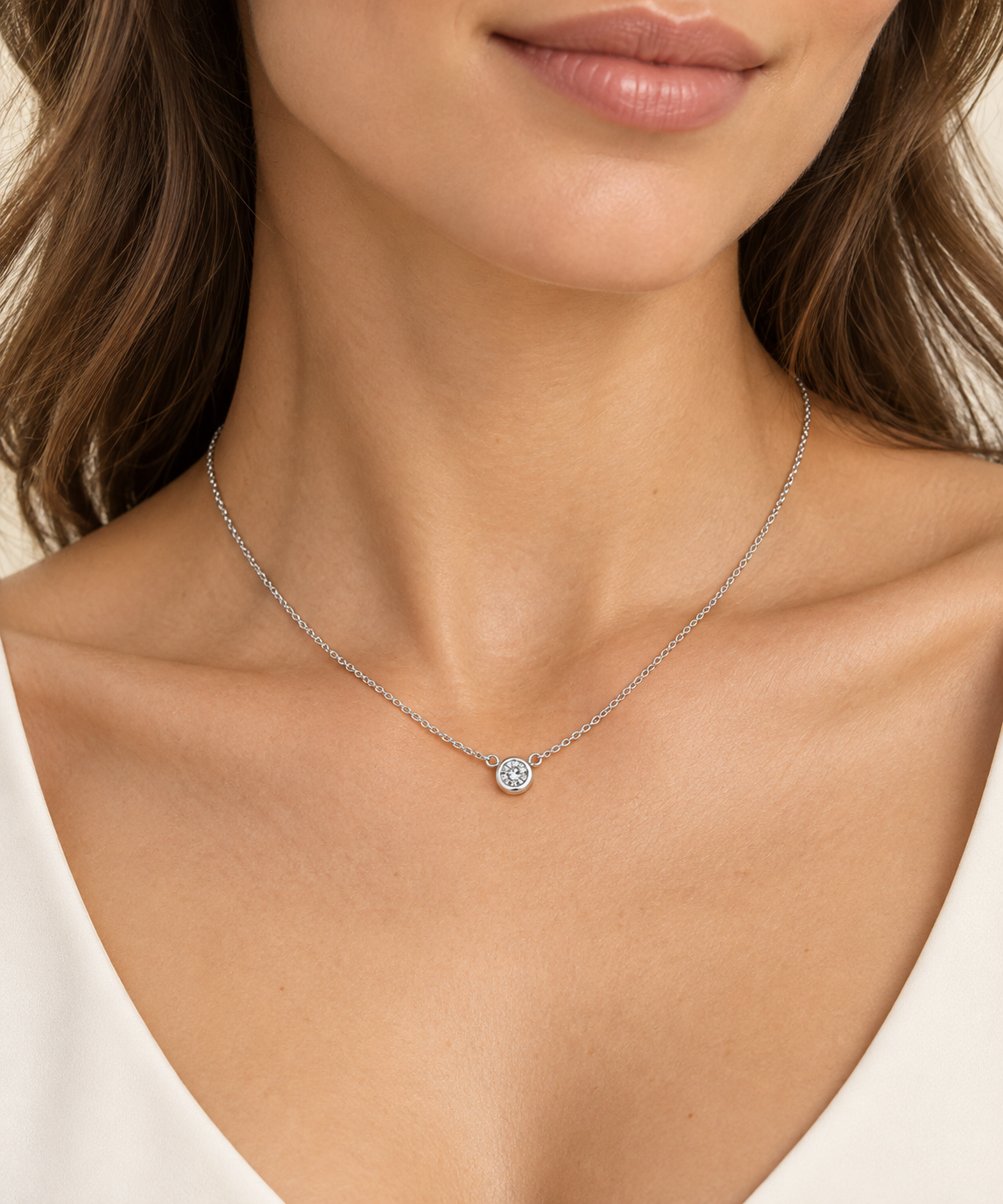 Floating 0.15CT lab grown diamond bezel set necklace close up on womans neck